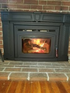 fireplace surrounded by brick wall